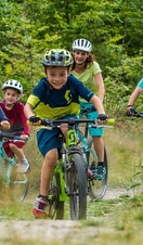 A group of children and parents cycling through the Leicestershire countryside