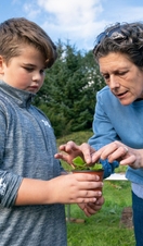 A woman and a child preparing a plant during growing activities at Northern Roots, Manchester