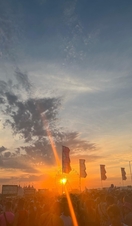 Sun setting over people at festival