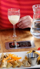 A person enjoying food and drink at a table
