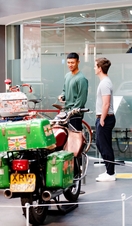 Two men looking at an exhibit of motorbikes at Coventry Transport Museum.