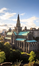 Aerial view of a cathedral on a sunny day with trees surrounding it