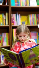 A girl reading a book in a bookshop, Blackwells. Oxford