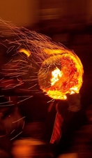 Participants run with a burning tar barrel through the streets.