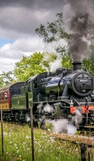 A steam train moving down a track