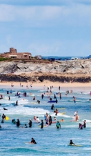 Surfers at fistral beach in newquay, cornwall, england, britain