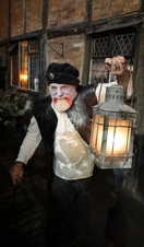 A man holding a lantern at Tudor World Museum