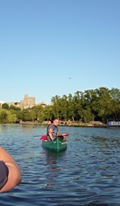Two people on a kayak posing for a photo on the River Thames