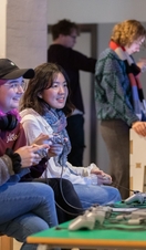A group of people playing a video game together at the National Video Games Museum in Sheffield