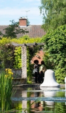 A couple sitting by a water fountain in Leicester's Botanic Gardens
