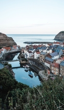 Aerial view of harbour, with boats, and village