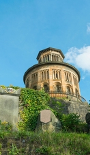 Old building with gravestones in foreground