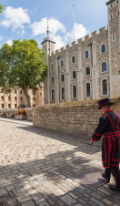 Beefeater walking by the, Tower of London on a sunny day