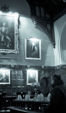 People sat in a historic hall on a ghost tour of Oxford