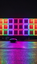 A colourful light installation at night.