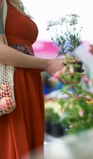 Woman shopping on local market with plastic free reusable bag. Truro, Cornwall