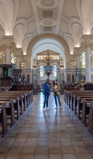 Two people standing inside a cathedral