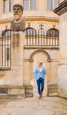 Man walking through a sandstone archway