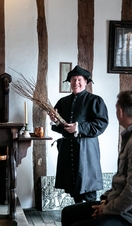 A tour guide showing exhibits at Shakespeare's Classroom in Stratford-upon-Avon