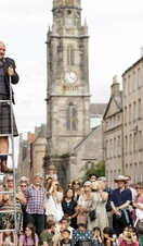 Street perfomer Peter Anderson, juggles swords in front of a crowd on the Royal Mile, Edinburgh, during the Festival Fringe 2022.