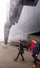 Three men exiting the Riverside Museum