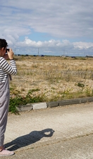 A female photographer in the Dungeness Landscape.