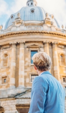 Man looking up at a historical building with dome