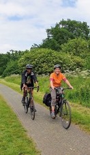 Two people cycling on a path in the countryside surrounding Birmingham