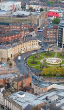 Aerial view of an expansive cityscape with a park and high-rise buildings
