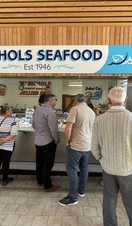 A group of people looking at seafood at a stall in Great Yarmouth