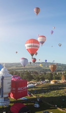 Colourful hot air balloons over floating above countryside