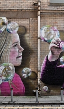 Mural on wall of kids blowing bubbles, Glasgow Mural Trail