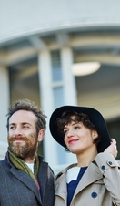 A man and woman standing outside the entrance of a gallery