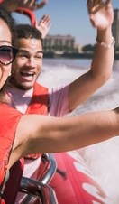 Close up of man young woman and man riding on speed boat on the Thames 
