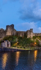 A long range shot of Pembroke Castle at night