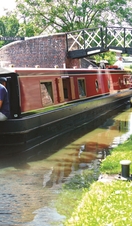 A family riding down a canal on a barge