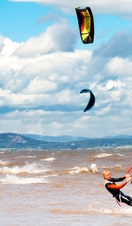 A group of people kite surfing just off the Lancashire coast