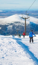 Group of skiers on a snowy slope in the Cairngorms National Park, Scotland