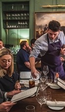 A group of people being waited on at a table in The Elder, Bath