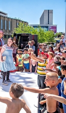 Performers on an outdoor stage at the Bradford Literature Festival