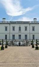 The northern facade and pristin gardens of a stately mansion.