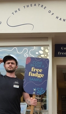 A member of staff posing outside the Fudge Kitchen in Windsor