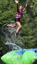 A girl bouncing on an inflatable at Dorset Adventure Park