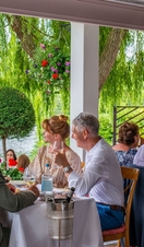 People eating and drinking at the Waterside Inn in Windsor