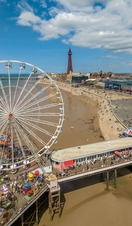 A busy seaside pier on a sunny day.