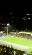 A packed football stadium at night 