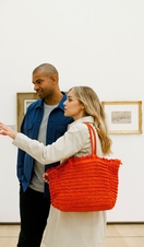 A couple examining a piece of art in Manchester's Art Gallery