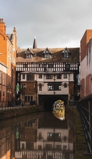 Black and white timber buildings hanging over the River Witham in Lincoln