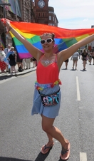 Woman flying rainbow flag during Pride