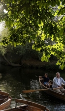 Family in a rowing boat on the river at Dedham Vale